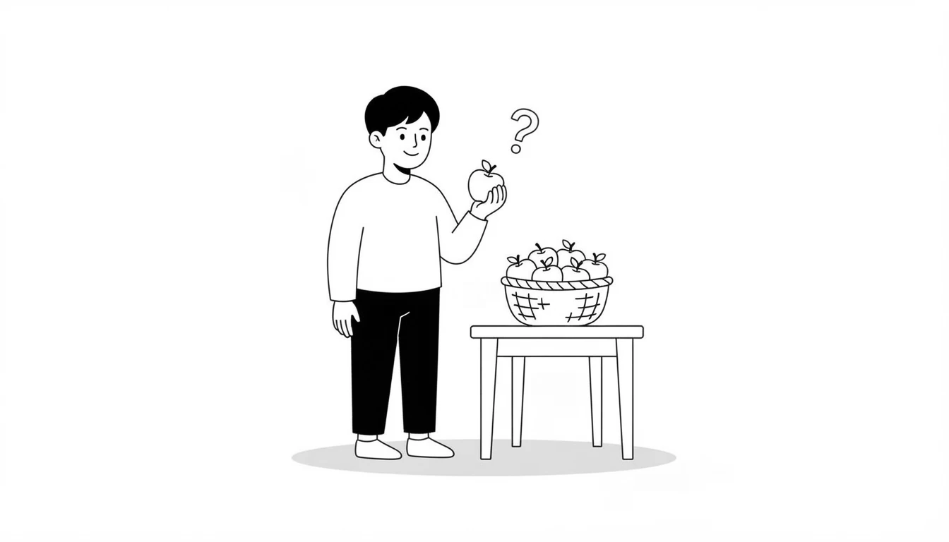 Smiling person holding an apple next to a table with a basket of apples